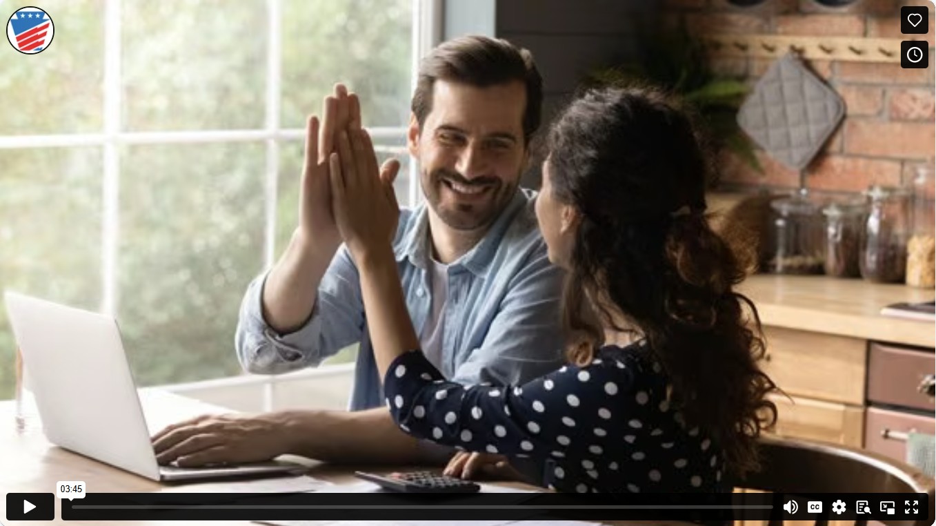 Screen shot of vimeo link, man and woman giving each other a high five while sitting at a table behind a laptop.
